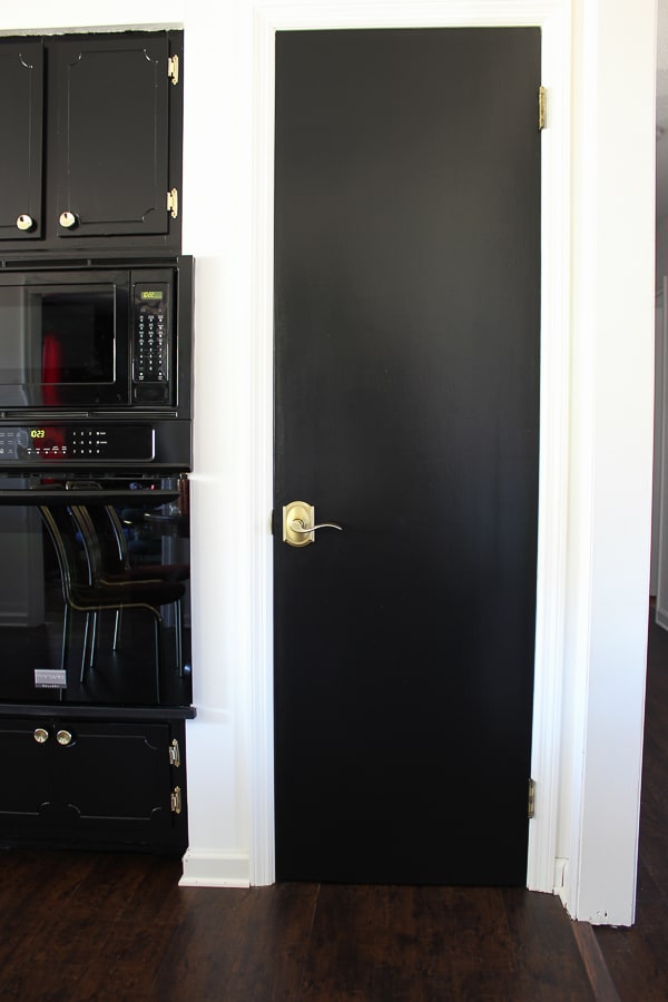 Black hollow core door with Schlage Accent lever in Satin Brass.