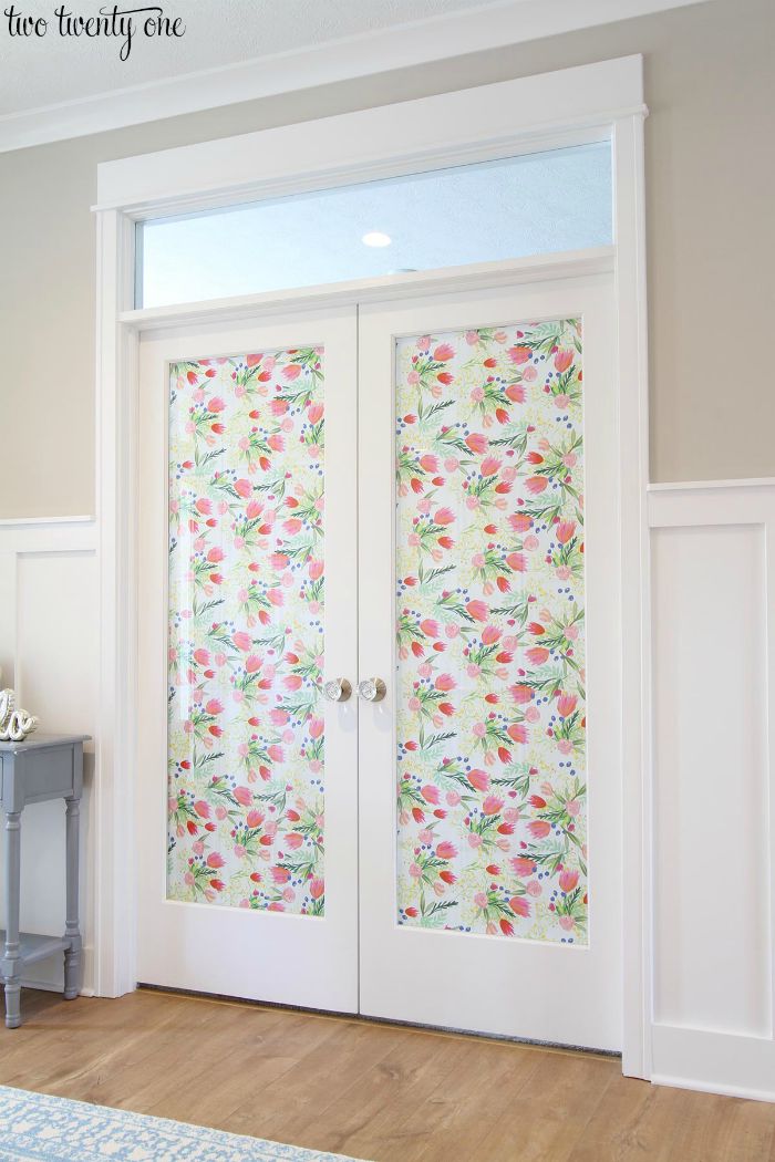 French doors with decorative paper and Schlage glass knobs.