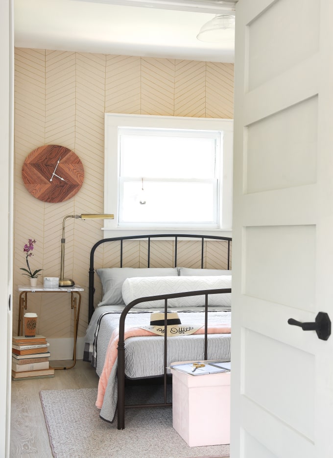 Guest bedroom with Black door hardware and brass lighting