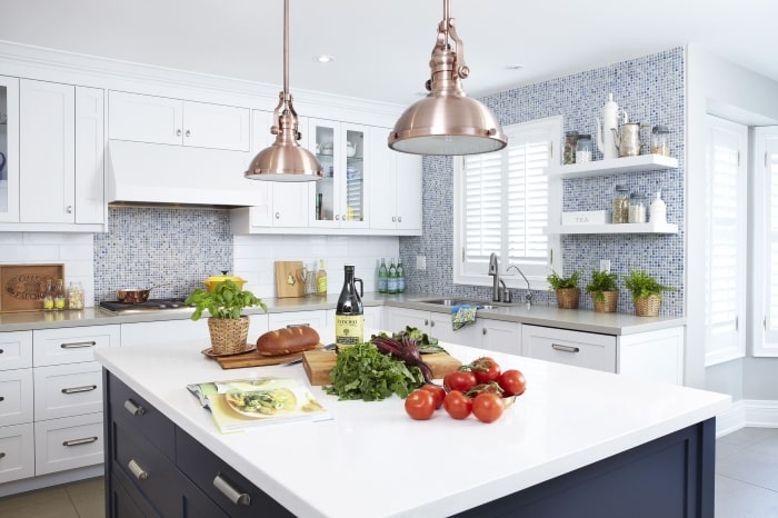 Kitchen with copper lighting and satin nickel hardware.