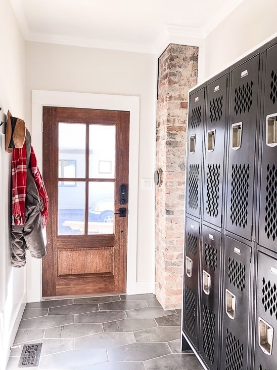 Mudroom with grey hex tiles and reclaimed lockers for storage.