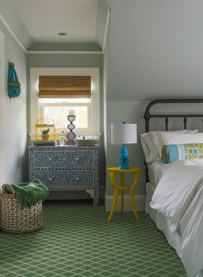 Green and blue guest bedroom with global inspired accents.