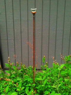 Door knob used as garden marker.