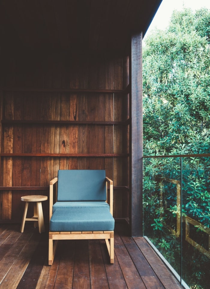 Lounge chair on minimalist balcony deck.
