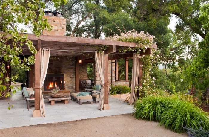 Neutral patio with pergola and drapes.