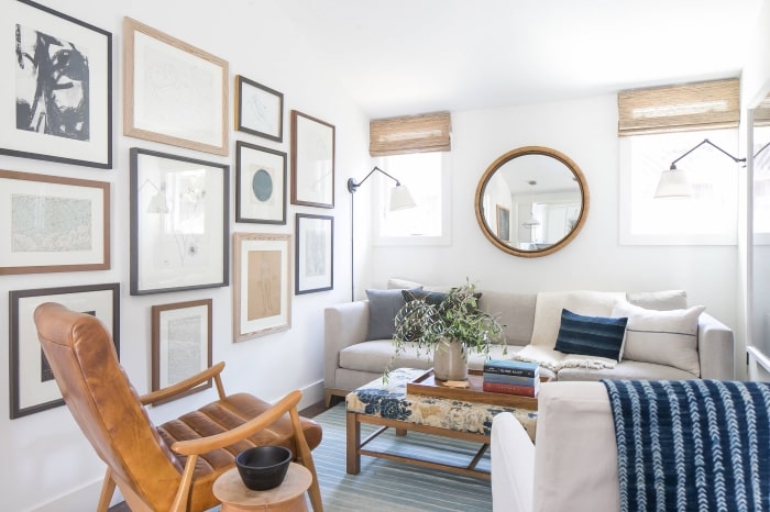 Coastal modern bungalow living room with mirror above couch.