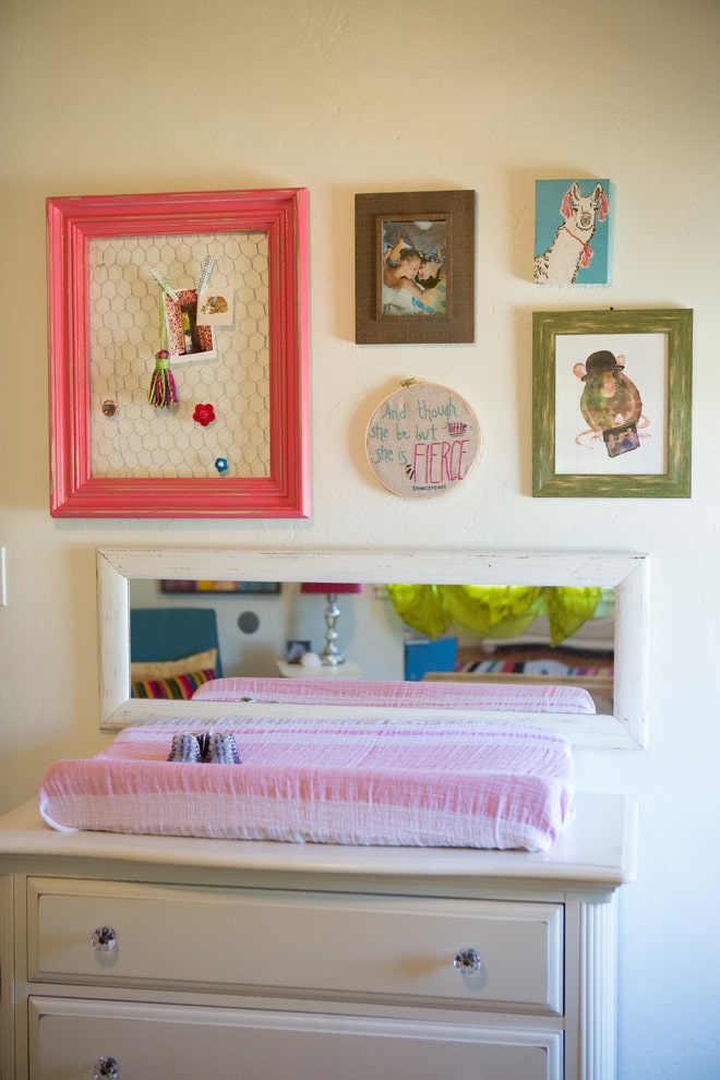Nursery with mirror by changing table.