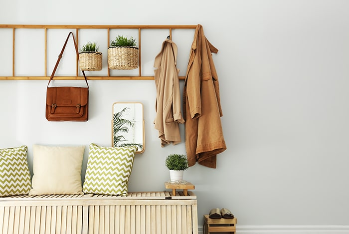 Minimalist entryway with bench and wall hooks.