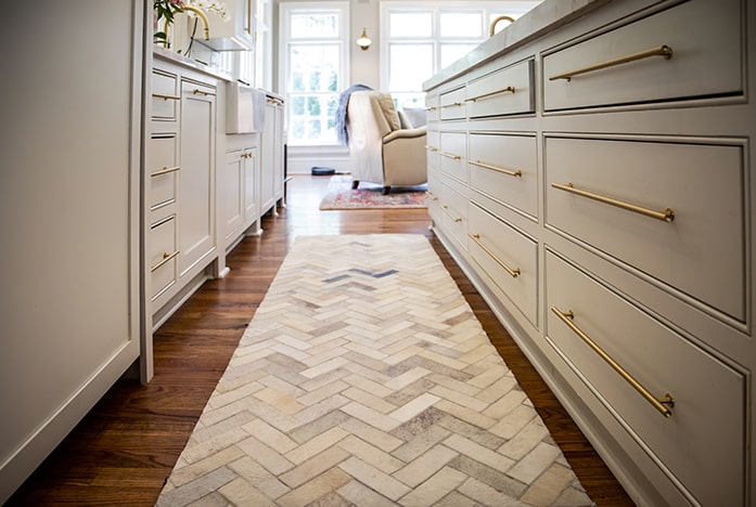 Modern kitchen with herringbone tile rug.