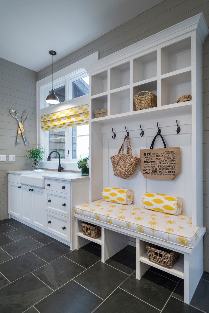 Mudroom with bench and farmhouse sink.