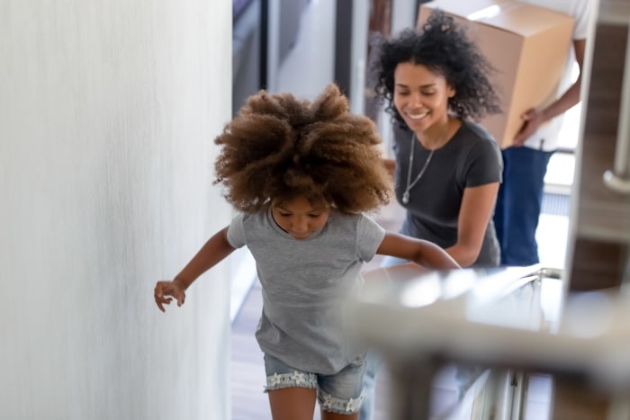 Little girl and parents moving into new home.