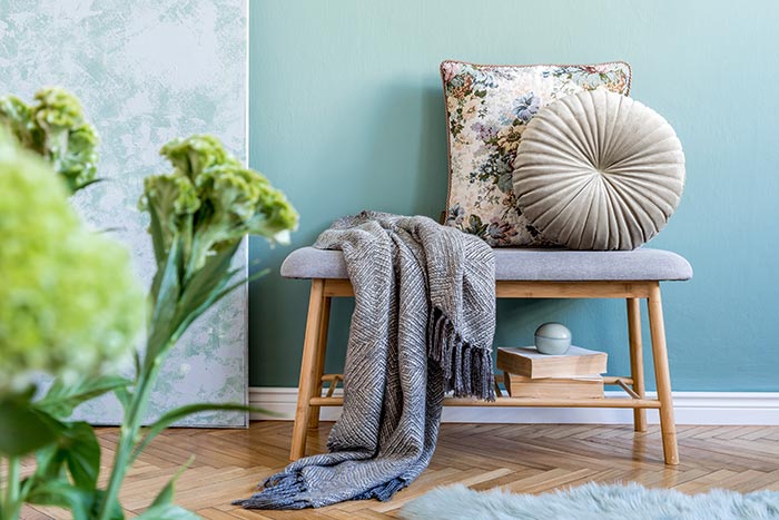 Mint blue entryway with bench and throw pillows.