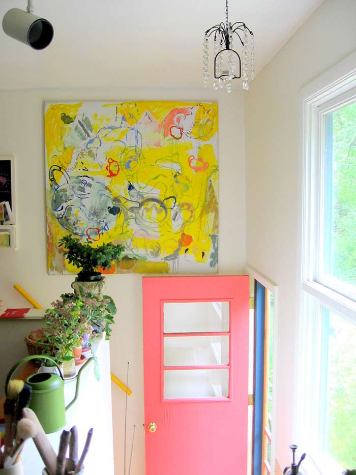 Back entryway with bright artwork and pink back door.