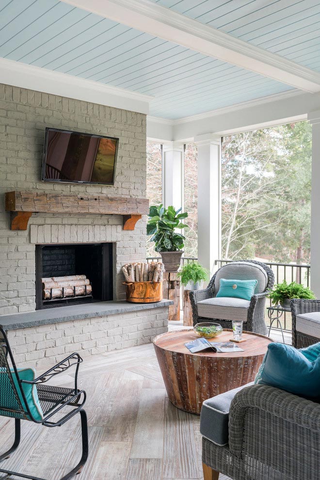 Back porch sitting area with fireplace and tv