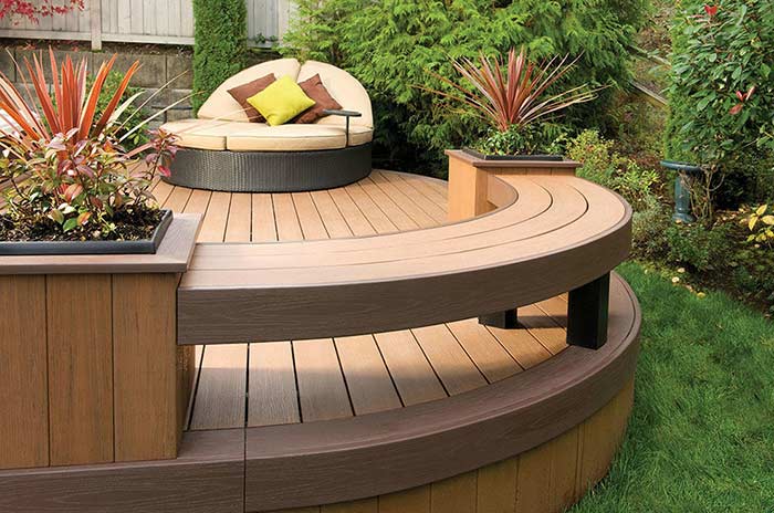 Composite deck with built-in planters and bench seating.