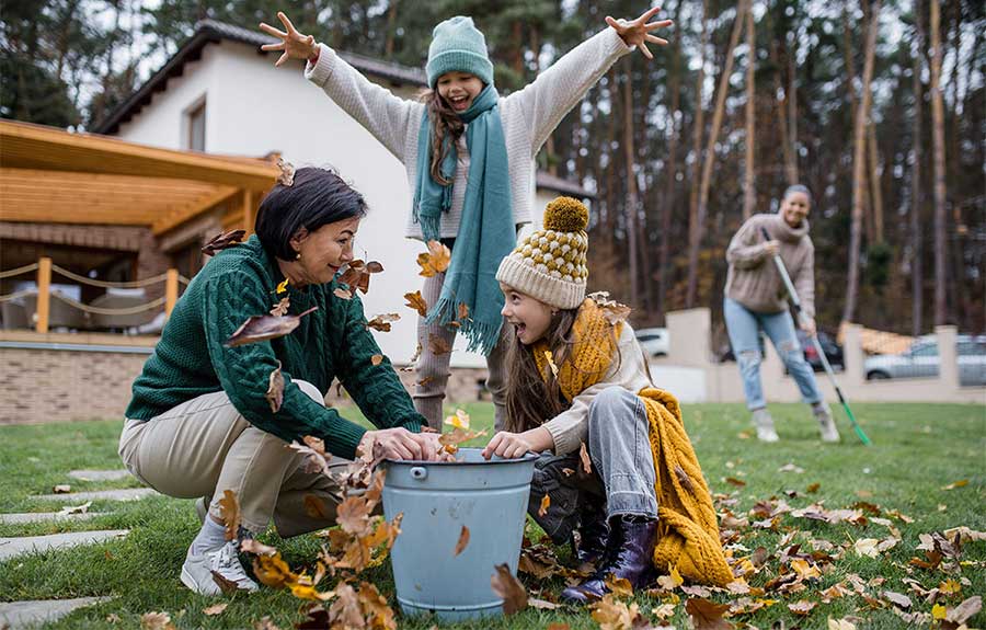 grandma and grankids having fun collecting autumn leaves