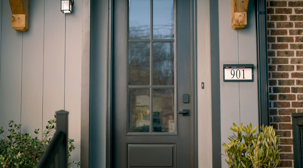 Schlage Sense Pro Ultra Wideband smart lock in matte black on gray door