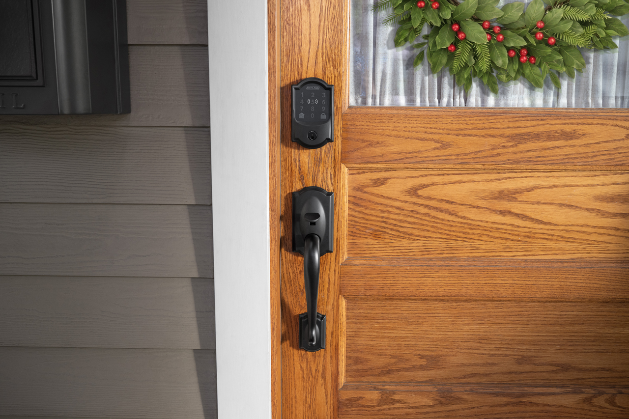 Home with a Christmas wreath hanging on a red front door