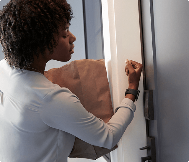 Woman opening door with watch