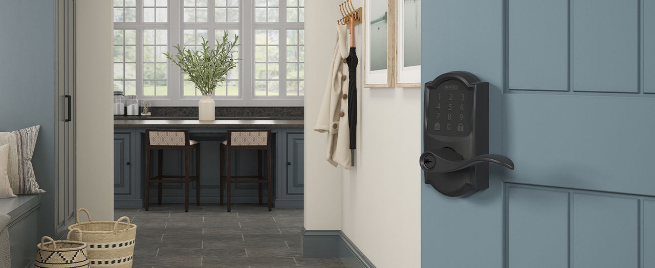 Matte Black Schlage Encode Smart Lever installed on open door revealing mudroom entry to home